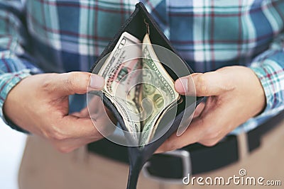 Close up business man standing hand hold Count the money spread of cash wallet. Stock Photo