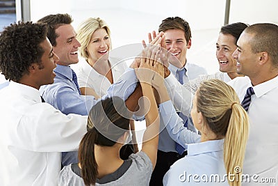 Close Up Of Business People Joining Hands In Team Building Exercise Stock Photo