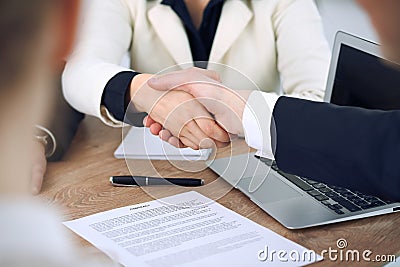 Close up of business people shaking hands at meeting or negotiation in the office. Partners are satisfied because Editorial Stock Photo