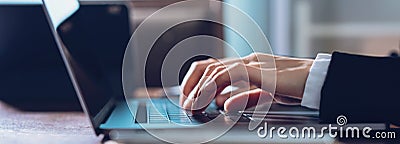 Close up of business woman hands typing on laptop computer and searching web, browsing in the workplace at office. Stock Photo