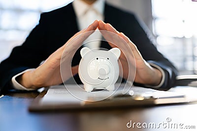 Close-up Of Businessman Hand Protecting Piggy Stock Photo