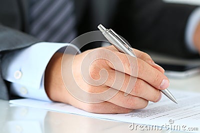Close up of businessman hands signing documents Stock Photo