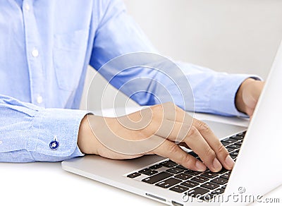 Close up of businessman hands typing on laptop computer Stock Photo