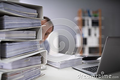 Businessman Hiding Behind The Folders Stack Stock Photo