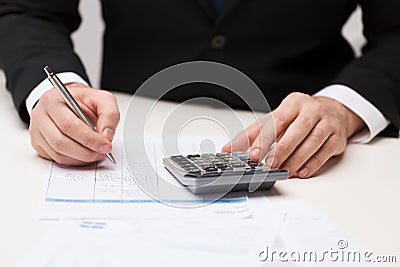 Close up of businessman with papers and calculator Stock Photo