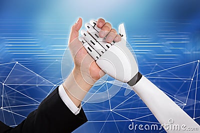 Businessman And Robot Doing Arm Wrestling Stock Photo