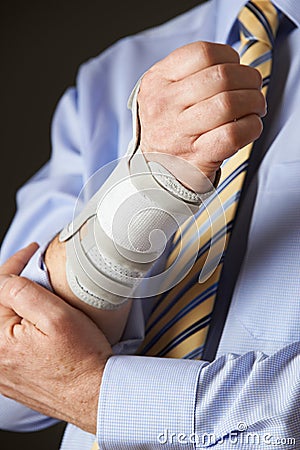 Close Up Of Businessman Suffering With Repetitive Strain Injury Stock Photo