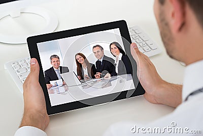 Businessman Videoconferencing With Digital Tablet Stock Photo