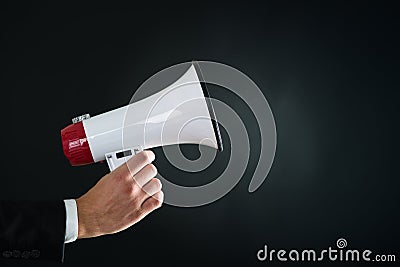 Close up of businessmans hand holding megaphone Stock Photo