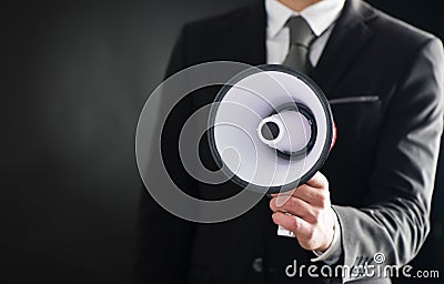 Close up of businessmans hand holding megaphone Stock Photo