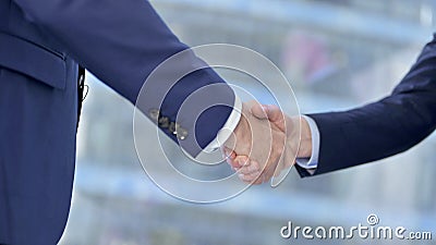 Close-up of Businessmen Shaking there Hands in Modern office Stock Photo