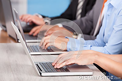 Close-up of businesspeople using laptop Stock Photo