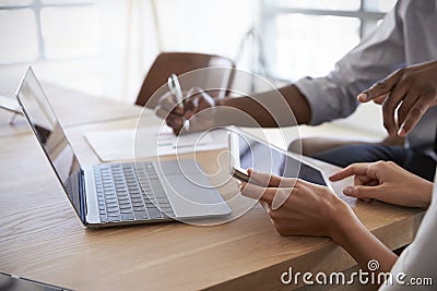 Close Up Of Businesspeople Working On Laptop In Boardroom Stock Photo