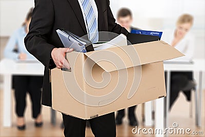 Businessperson Carrying Cardboard Box Stock Photo