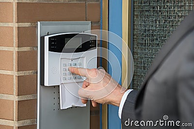 Close-up Of Businessperson Entering Code In Security System Stock Photo