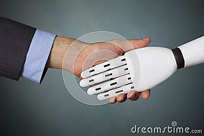 Businessperson And Robot Shaking Hands Stock Photo