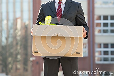 Close-up Of Businessperson Standing With Cardboard Box Outside O Stock Photo