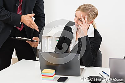 Businessperson Talking To Stressed Employee Stock Photo