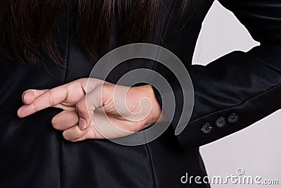 Close up businesswoman with her fingers crossed behind her back - concept for good luck or dishonesty business Stock Photo