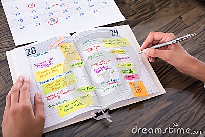 Businesswoman Making Agenda On Diary Stock Photo