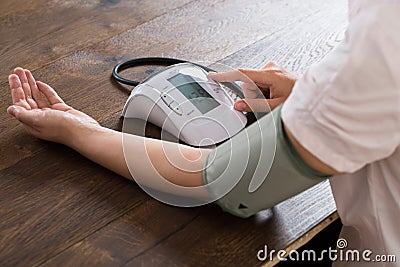 Close-up Of Businesswoman Measuring Blood Pressure Stock Photo