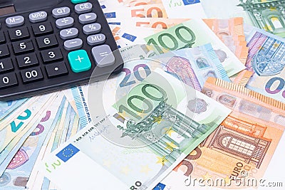 Calculator on Euro banknotes. Euro money bills to pay. Finances and budget concept. Tax and money Stock Photo