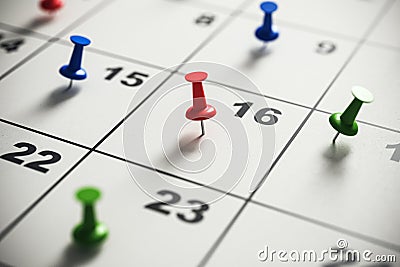 Close-up of a calendar with colorful pins marking important dates. Time management and planning concept. Stock Photo