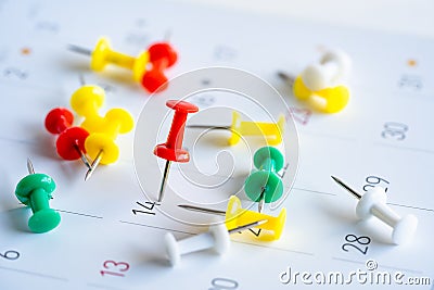 Close Up Calendar with numbers marked with red push pins. Stock Photo