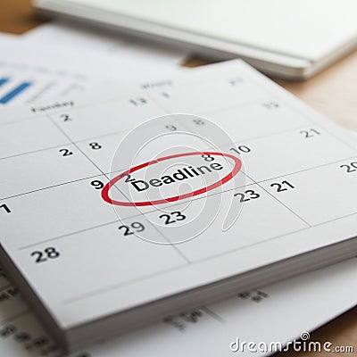 A close-up of a calendar page showing dates in a grid format. One date is marked Stock Photo
