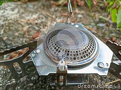 close up of camping gas stove on the grass. portable lightweight stove for hiking, camping, and backpacking. Stock Photo