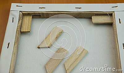 Close-up of a canvas stretched over a frame with wooden struts. Craft workshop, canvas making and stretching. Selective focus Stock Photo