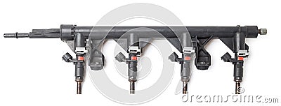 Close-up on a car fuel rail with injectors for supplying gasoline to a four cylinder engine on a white isolated background. Spare Stock Photo