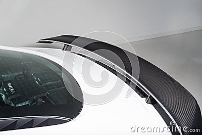 Close up of carbon fibre rear spoiler on white sports car Stock Photo