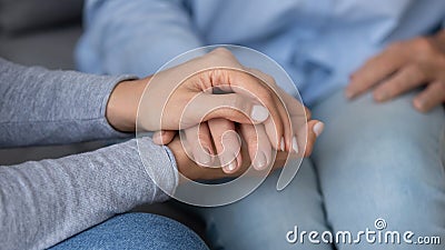 Close up caring granddaughter holding grandmother hand, supporting Stock Photo