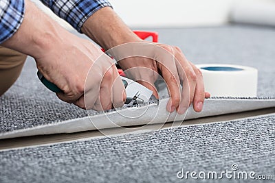 Carpenter Laying Carpet Stock Photo