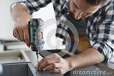 Close up of carpenter using a cordless drill Stock Photo