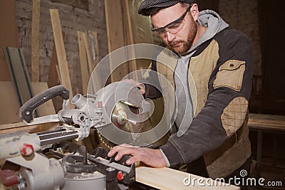 Close-up of a carpenter doing woodwork. a small business owner was cutting a wooden Board with a circular saw in a workshop Stock Photo