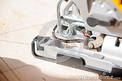 Close-up carpenter working with an electric jigsaw.man cuts wood with an electric jigsaw. Electric tool for woodworking Stock Photo