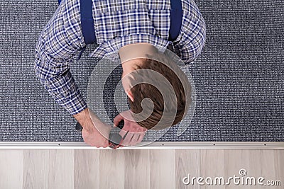 Carpet Fitter Installing Carpet With Wireless Screwdriver Stock Photo