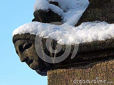 Close up of the carving of a womans face in profile on the corner of the ancient ruined medieval church in heptonstall Stock Photo
