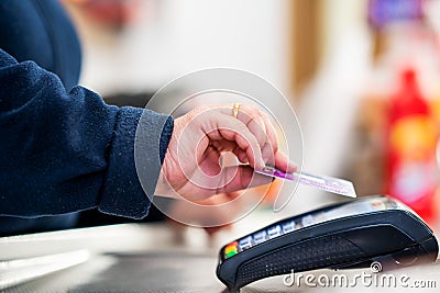 Close up of cashier is using contactless credit card pos terminal to getting the payment. Stock Photo