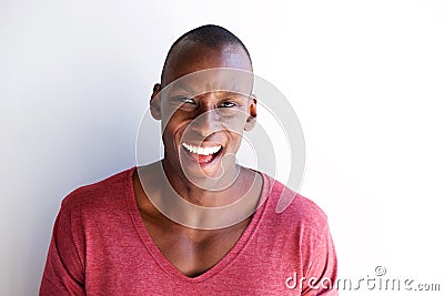 Close up charming african american man laughing by white wall Stock Photo