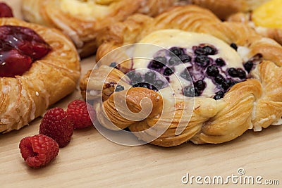 Close up of cheese danishes puff pastry with cherry jam, blackberries and fresh raspberries Stock Photo
