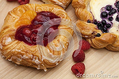 Close up of cheese danishes puff pastry with cherry jam, blackberries and fresh raspberries Stock Photo