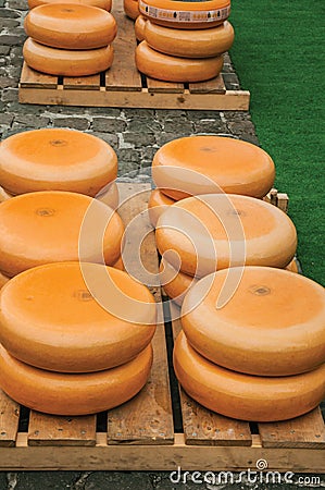 Close-up of cheeses stacks for sale at the Market Square fair in Gouda. Editorial Stock Photo