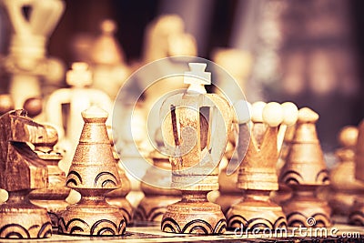 Close up of chessboard with wooden pieces on table in sunlight. Chess game, close up image with selective focus Stock Photo