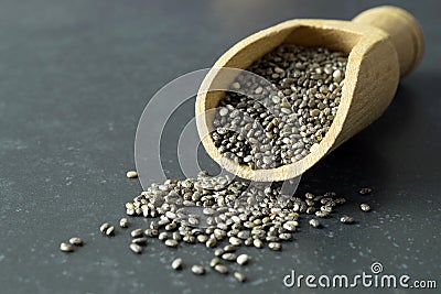 A close up of chia seeds in a wooden scoop Stock Photo