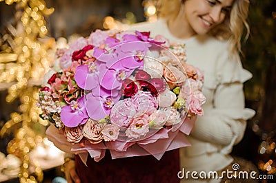 Close-up of chic expensive bouquet of pink flowers in round red box. Stock Photo