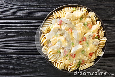 Close-up of chicken a la king cooked breast of chicken in a cream sauce with mushrooms, green peas and chopped peppers in the Stock Photo