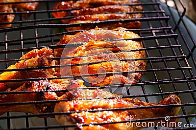 close-up. chicken steaks on a grill rack cooking over an open fire Stock Photo